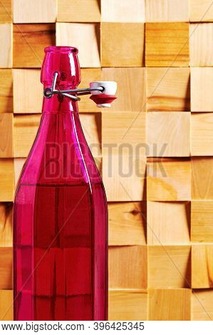 Vintage Pink Rare Wine Bottle On The Wooden Table In The Cellar. Wine Drinks And Rare Handmade Bever