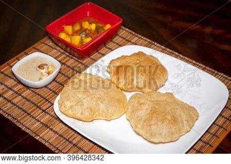 India dish home cooked Poori and mixed vegetable curry along with desert