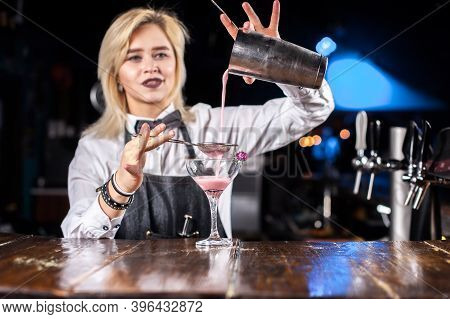 Girl Bartender Mixes A Cocktail In The Porterhouse