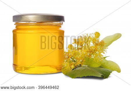 Full Jar With Linden Honey And Lime Flowers Isolated On White Background.