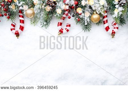 Christmas Border - Tree Branches With Golden Baubles, Candies And Cones On Snow