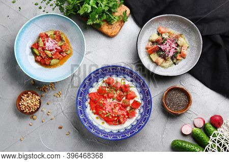 Many Salad On Light Concrete Table Top Vie. Ceviche With Tuna, Salmon And Stracciatella With Tomatoe