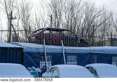 Old Car Is Installed On The Facade Of The Building.