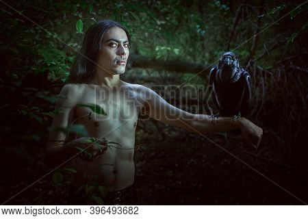 A Creepy Man With A Raven On His Hand Looks Like A Demon.
