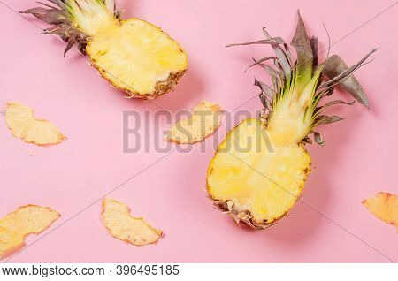 Ripe Juicy Pineapple On Pink Background And Dried Pineapple Wedges Around. Fruit Chips. Healthy Eati