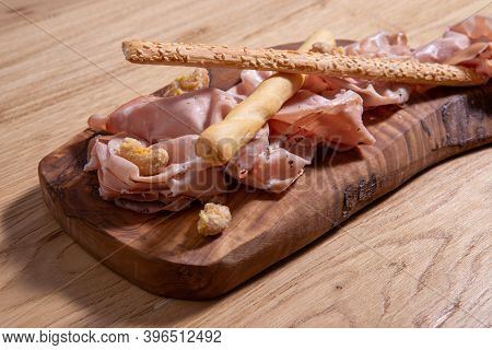 Set Of Mortadela Slices On A Wooden Table. Italian Salami.