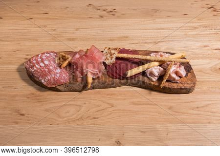 Set Of Cold Cured Spanish Meat Ham, Mortadela And Lomo On A Wooden Background.