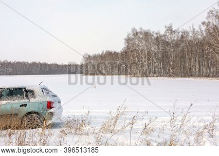 Danger Of Getting Stuck In Snow. Unexpected Snowfall Covered Car With Snow. Winter, People And Car P