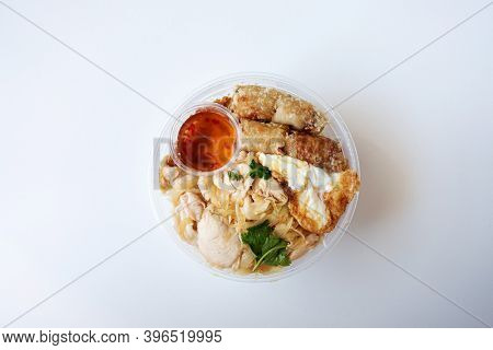 Delicious Vietnamese Bo Bun prepared with rice vermicelli noodles for basics and for topping chicken pieces and fried spring rolls