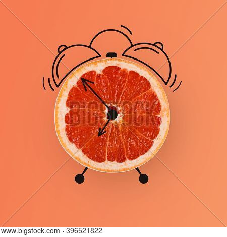 Creative Collage With Half Cut Of Grapefruit Designed As Clock With Drawn Arrows And Ring Bells Isol