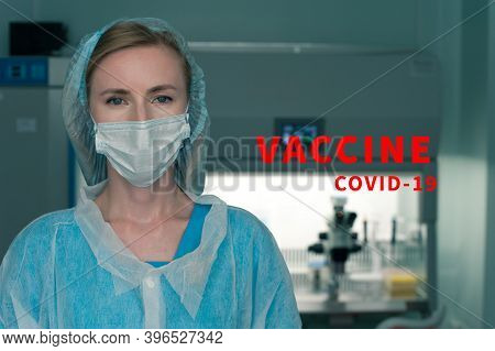 Woman Microbiologist Posing On The Background Of Medical Laboraty. The Concept Of Creating New Coron