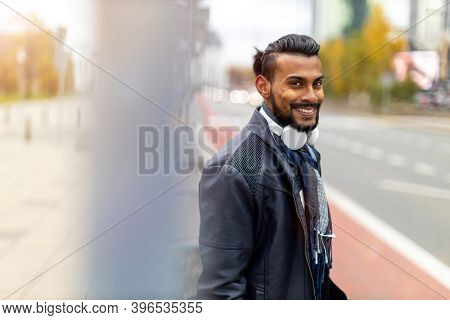 Portrait of a handsome young man on the city street 