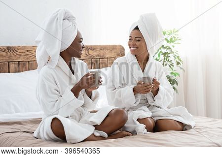 Cheerful African American Ladies In Bathrobes Spending Time Together At Home, Having Reaxing Spa Day