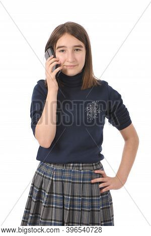 Pre-adolescent Girl Called On Black Smartphone. Isolated On White Background. High Resolution Photo.