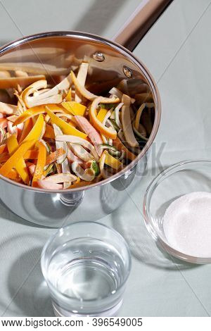 Sliced Citrus Fruit Peel For Cooking Candied In A Stainless Saucepan. Concept Reducing Food Waste