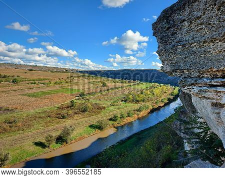 Beautiful Landsaft Of Rocky Hills That Is Crossed By A Meandering River. Sunny Day With Blue Sky Wit