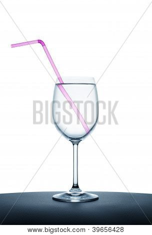 Pink Drinking Straw In The Wine Glass Full With Water