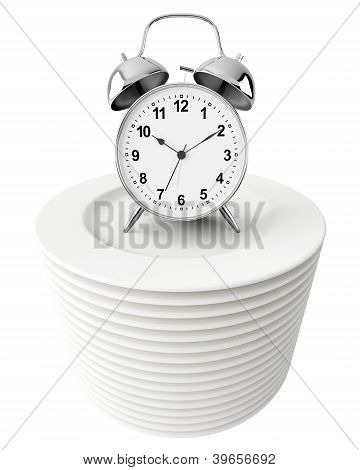 Alarm Clock On Stack Of Plates Isolated