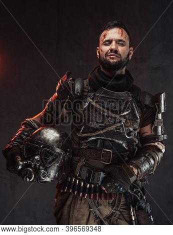 Cheerful And Smiley Post Apocalyptic Fighter Dressed In Ragged And Dirty Armour Holding Helmet In Da