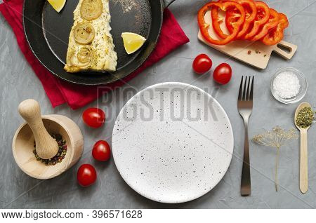 Fried Baked Mackerel Trachurus With Onions And Dried Herbs In Old Frying Pan. Vegetables And Applian