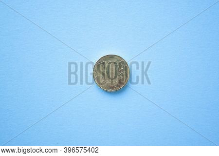 Coin Ten Rouble On Bright Blue Background. Ruble Depreciation. Rouble To Dollar
