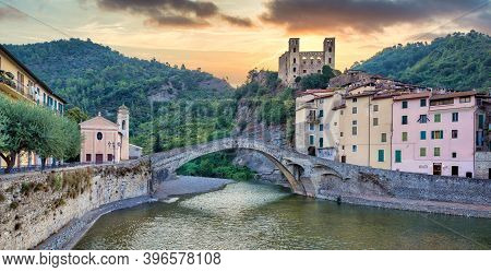 Dolceacqua, Italy - Circa August 2020: Dolceacqua Panorama With The Ancient Roman Bridge Made Of Sto