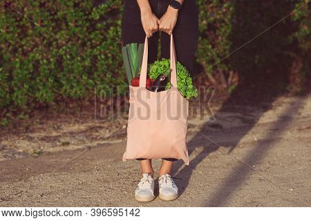Woman With Pink Reusable Eco Bag With Fresh Bio Vegetables. Plant Based Vegan Diet Shopping. Healthy