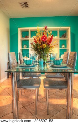 Tropical Blue Table Set With Flowers Including Heliconia Bihai, Yellow Oncidium Orchids
