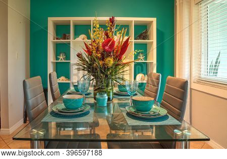 Tropical Blue Table Set With Flowers Including Heliconia Bihai, Yellow Oncidium Orchids