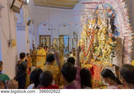 Blurred Image Of Worshipping, Flowers Are Thrown, Prayers Made And Pushpanjali Being Offered By Hind