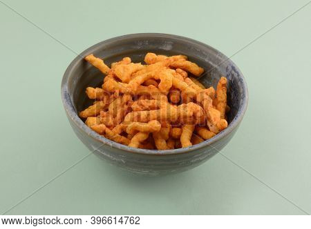 Spicy Hot Indian Puffed Rice Snack In Ceramic Bowl On Green Background
