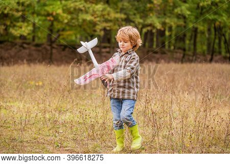 Little Kid Dreams Of Being A Pilot. Child Playing With Toy Airplane. Happy Child Playing. Happy Chil