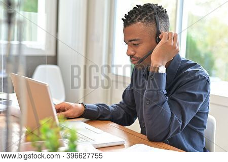 Office-worker with headset on, attending online business conference