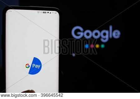 Google Pay App Logged In On A Mobile Infront Of A Black Screen With Google Symbol