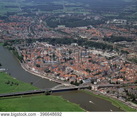 Deventer, Holland, July 11 - 1990: Historical aerial photo of the city Deventer situated on the east bank of the river IJssel and Wilhelminabrug  