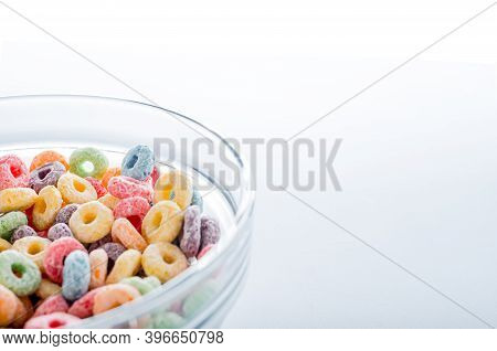 Colored Fruit Grain Loops In A Bowl.on A Blue Background