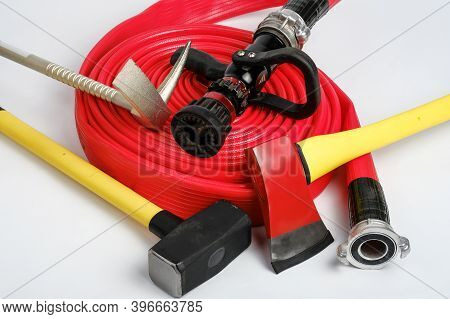 Large Yellow Sledgehammer, Axe, Hooligan Pinch-bar And Rolled Fire Hose From Firemans Toolbox On Whi