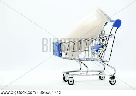 Natural Yogurt With Probiotics And Lactobacillus In Small Plastic Bottles In Metal Supermarket Troll