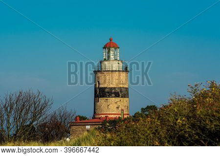 A Brick Lighthouse With A Bright Blue Sky In The Background. Picture Of Falsterbo Lighthouse Built I