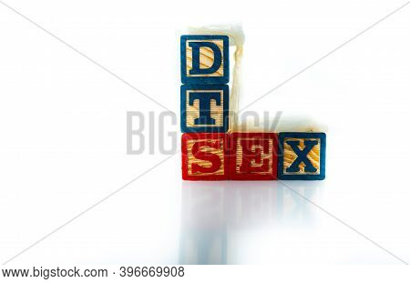 Wooden Alphabet Toy Blocks Spell The Words Std And Sex. A Used Condom Sits On The Blocks, Isolated O