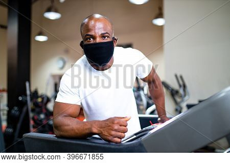 Spain Man In White Cotton T-thirt Wearing Mask While Working Out In Gym