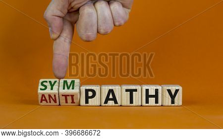 From Antipathy To Sympathy. Male Hand Turns Cubes And Changes The Word 'antipathy' To 'sympathy'. Be