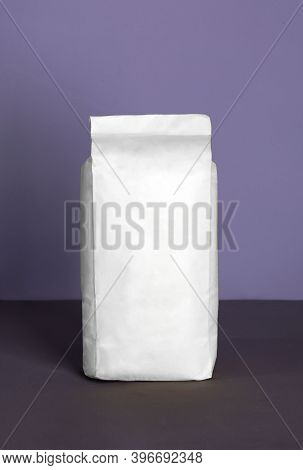 Small Blank Bulky White Package With Product On A Purple-lilac Background . Ready For Shipping, Deli