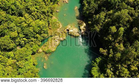 Aerial Drone Of Tropical Loboc River In The Rainforest. Mountain River Flows Through Green Forest. B