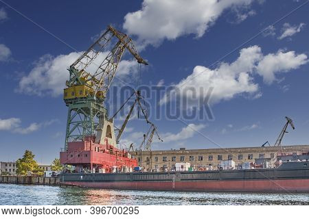 Crane On The Background Of Old Buildings Of The Sevastopol Marine Plant Named After Sergo Ordzhoniki