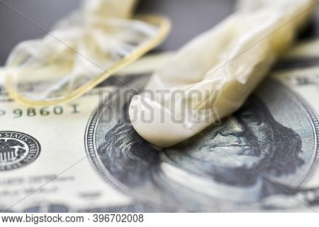 Used Condom With Cum And Us Dollars Bills. Prostitution Concept. Pay For Sex Per Night. Harlotry And