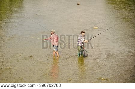 Deep In Water. Hobby And Sport Activity. Trout Bait. Two Happy Fisherman With Fishing Rod. Big Game 