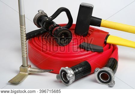 Red Rolled Fire Hose, Hooligan Pinch-bar, Large Yellow Sledgehammer And Axe From Firemans Toolbox On