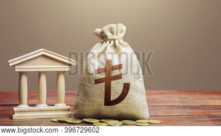 Turkish Lira Money Bag And Bank / Government Building. Monetary Policy. Tax Collection And Budgeting
