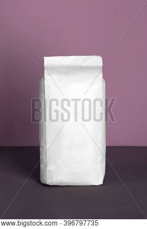 Small Blank Bulky White Package With Product On A Purple-lilac Background . Ready For Shipping, Deli